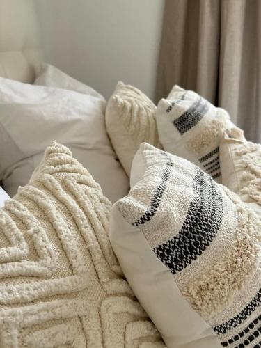 a pile of pillows sitting on top of a bed at Wanderlust East73 in Trier