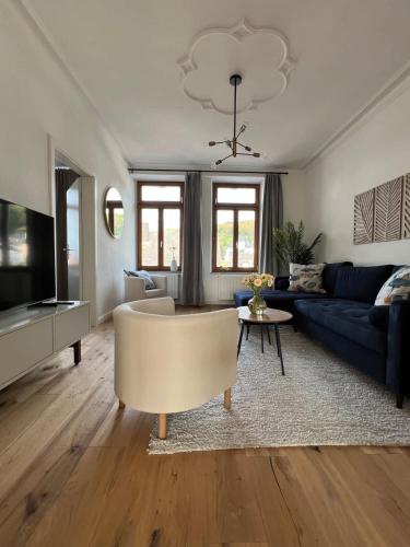 a living room with a couch and a tv at Wanderlust East73 in Trier