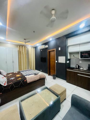 a large room with a bed and a kitchen at cozy noida studio, super comfy!!!! in Noida