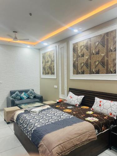 a bedroom with a bed and a couch in it at cozy noida studio, super comfy!!!! in Noida