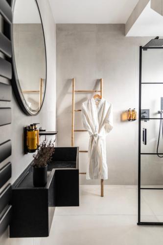 a bathroom with a black sink and a mirror at Norte Luxury Villas in Agioi Apostoli