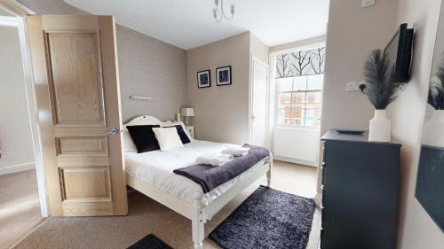 a small bedroom with a bed and a window at Seasons in Weymouth