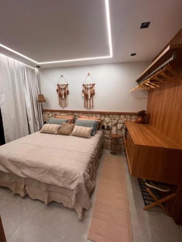 a bedroom with a large bed and a piano at Mucugê- Charm Village in Mucugê