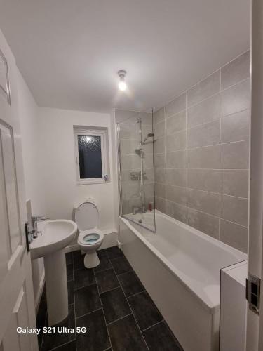 a bathroom with a sink and a toilet and a shower at Modern 2BR House Sleeps 5 Free Parking Contractor Friendly Van parking in Middlesbrough