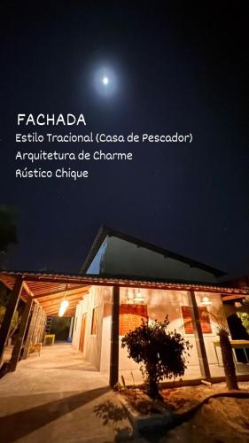 a picture of a house at night with the moon at Casa Passarela in Icapuí
