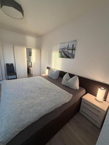 a bedroom with a large bed with two pillows at Seglerblick in Greifswald