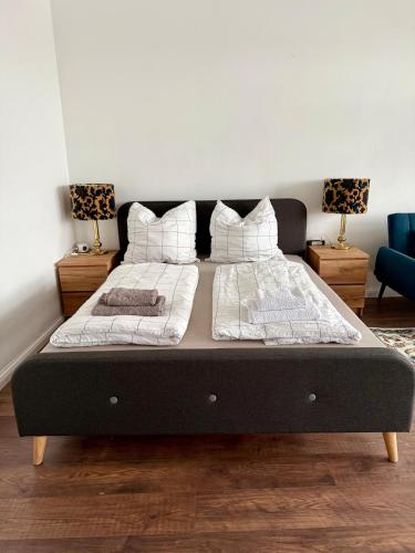 a large bed in a bedroom with two pillows at Stilvolle Wohnung mit Rheinblick in Weißenthurm