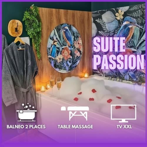 a room with a bathtub and a table with a towel at Suite Passion - Jacuzzi privé - Table massage in Saint-Étienne