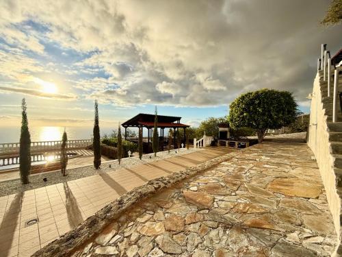 a gazebo next to the ocean with a cloudy sky at Villa Tequila in Tijoco de Abajo