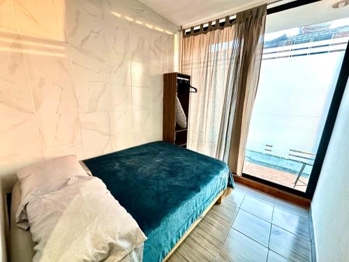 a bedroom with a bed and a large window at Alojamientos Xolotl in La Concepción