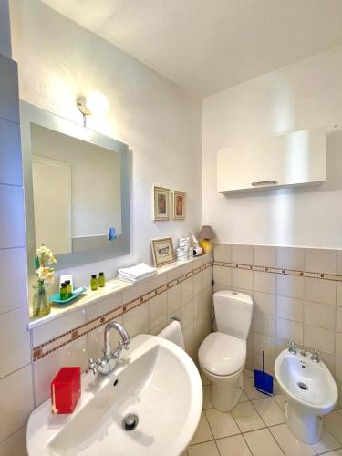 a bathroom with a sink and a toilet and a mirror at Casa Vacanze Pinuccia in Corniglia