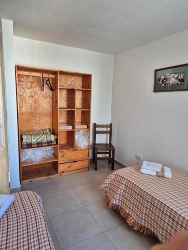 a room with two beds and a chair in it at Rent Santa Clara in Santa Clara del Mar