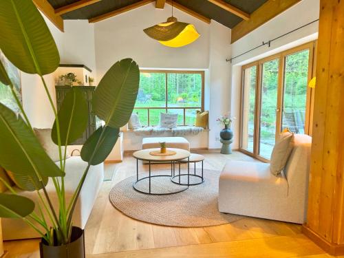 a living room with a couch and a table at Ferienhaus "Bodenschneid" am Schliersee in Schliersee
