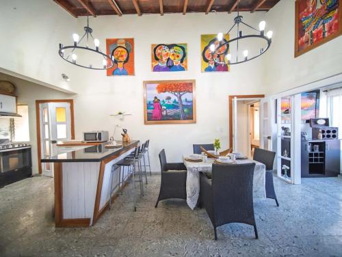a kitchen and dining room with a table and chairs at Colonial 2BR Apartment 2 mins walk to beach in Sosúa