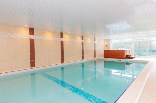 a large swimming pool with a large blue swimming pool at Buzzards Retreat in Tiverton