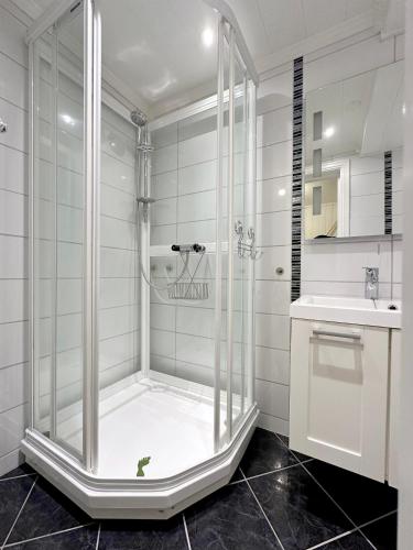 a shower with a glass door in a bathroom at Apartment centrally located in Bud in Bud