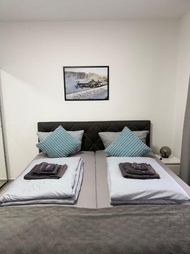a bedroom with a bed with two pillows on it at Ferienwohnung Menges in Medebach