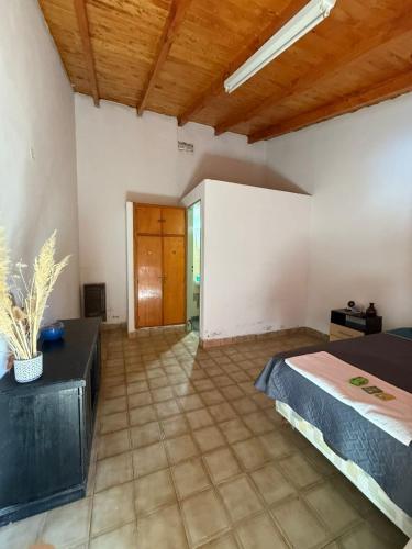 a bedroom with a bed and a wooden ceiling at Bracco in Chos Malal
