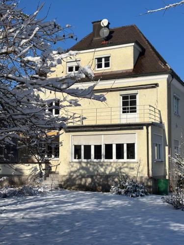 a house with snow on the ground in front of it at Villa Vilma Antica in Laufen