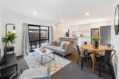 a living room with a couch and a table at Relaxed Stay in Modern Comfort - By Superior Stays in Hamilton
