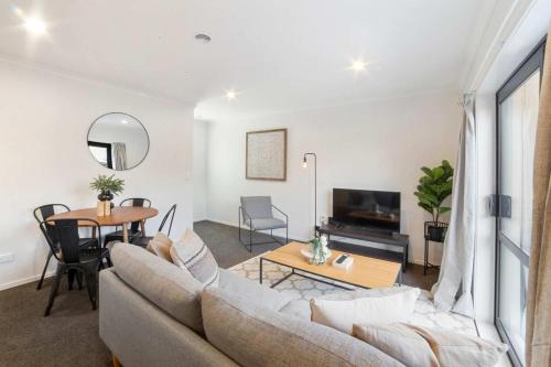 a living room with a couch and a table at Relaxed Stay in Modern Comfort - By Superior Stays in Hamilton