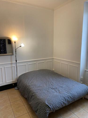 a bedroom with a bed and a lamp in it at Studio centre ville in Nevers