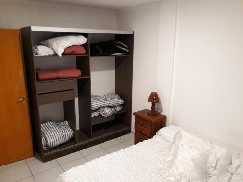 a room with a bedroom with a bed and a closet at Tafi Apart in Sarmiento