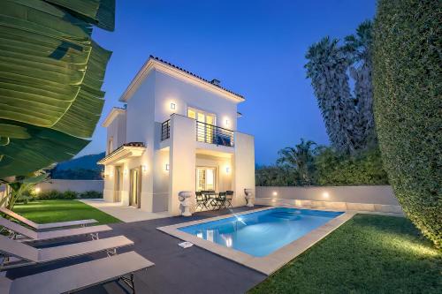a villa with a swimming pool at night at Sintra Dream Garden Villa near Cascais in Sintra