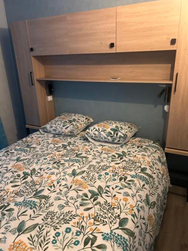 a bed with two pillows on it in a bedroom at Gîte de la Vigne in Ley
