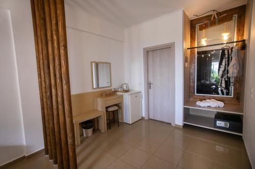 a bathroom with a sink and a desk and a mirror at Filoxenia Sea View in Parga