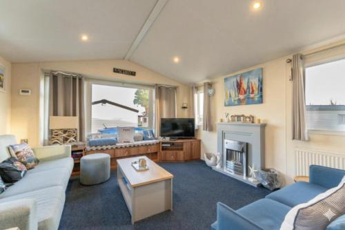 a living room with a couch and a fireplace at Captain's Quarters B67 in Brixham