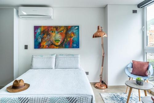 a bedroom with a bed and a painting on the wall at Loft 202 North Cali - Montsari in Cali