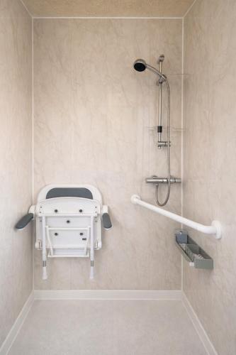 a bathroom with a shower and a white sink at The City Gateway Villa in Manchester