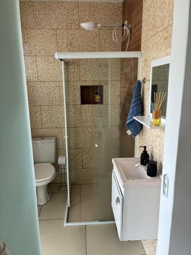 a bathroom with a shower and a sink and a toilet at Refúgio Rio Soberbo in Guapimirim
