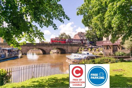 a train on a bridge over a river with a sign at La casetta d'Àneu in Oxford