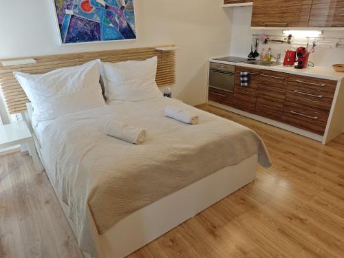 a bedroom with a large bed with two pillows on it at Apartmán SOVA - Klínovec in Loučná pod Klínovcem