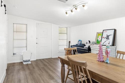 a dining room with a wooden table and chairs at House - Minutes from Siesta Key! in Sarasota