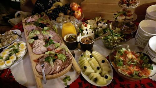 a table filled with plates of food on a table at Chata nad stawem in Wierchomla Mała