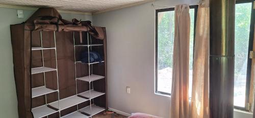a room with a closet with shelves and a window at Casa ecologica artesanal in Santa Ana