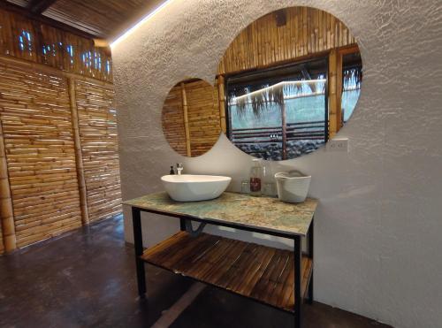 a bathroom with a sink and a mirror at Izotal Bioluxury Hotel in Taminango