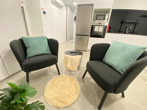 a living room with two chairs and a couch at Casa do Pelourinho in Arcos de Valdevez