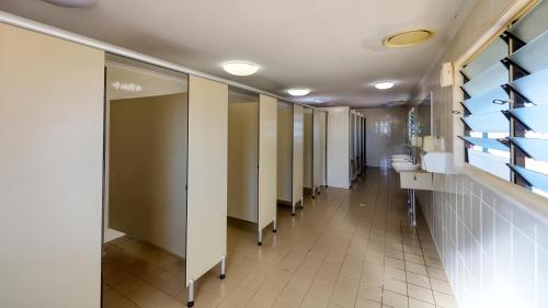 a row of stalls in a public restroom at Longreach Tourist Park in Longreach