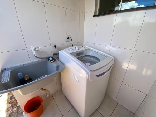 a small bathroom with a toilet and a sink at Casa Becker in Laranjeiras do Sul
