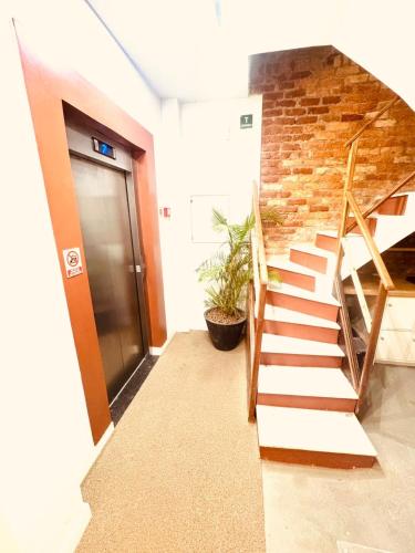 a staircase in a building with a brick wall at Elohim Residencial in Rio de Janeiro