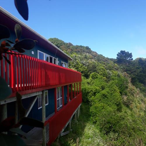 a red and blue train traveling through a mountain at Wellington Vibes in Wellington