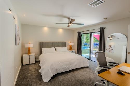 a bedroom with a white bed and a desk and a desk at Luxury Scottsdale Retreat with Heated Pool, Hot Tub, Fire Pit & Game Room & Sleeps 12 in Scottsdale