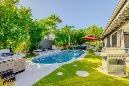 a backyard with a swimming pool and a lawn at Luxury Scottsdale Retreat with Heated Pool, Hot Tub, Fire Pit & Game Room & Sleeps 12 in Scottsdale