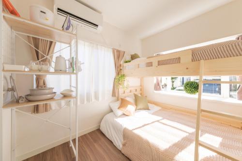 a bedroom with a bunk bed and a window at Hotel Emile 101 in Tachikawa