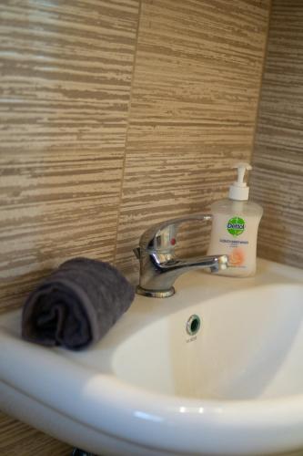 a bathroom sink with a bottle of soap on it at Hidden gem agora flat Checkpoint-Mytilene in Mytilene