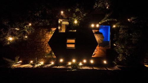 a building with a blue light at night at Zamaya Bangalôs in Sao Jorge